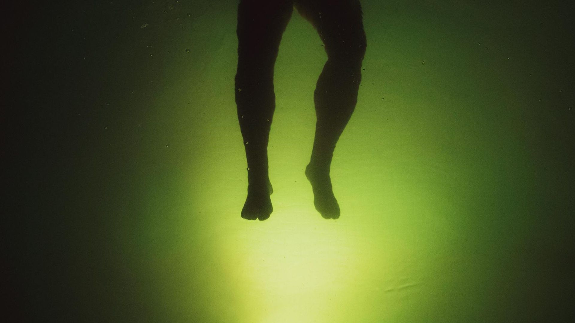 Abstract motion silhouette in dark room with green glow